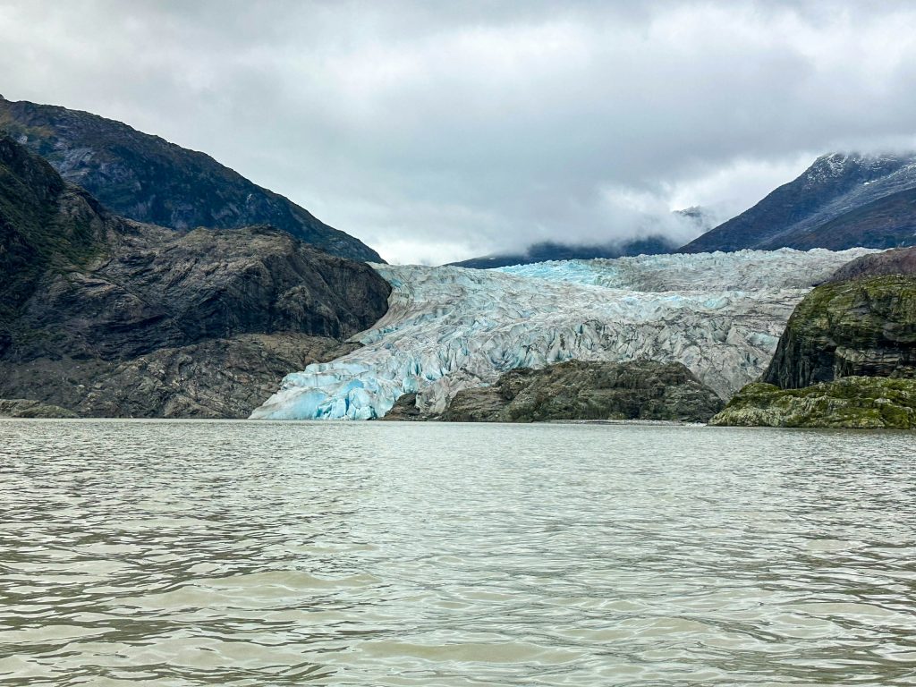 Mendenhall Glacier's blue ice face meeting Mendenhall Lake near Juneau, Alaska